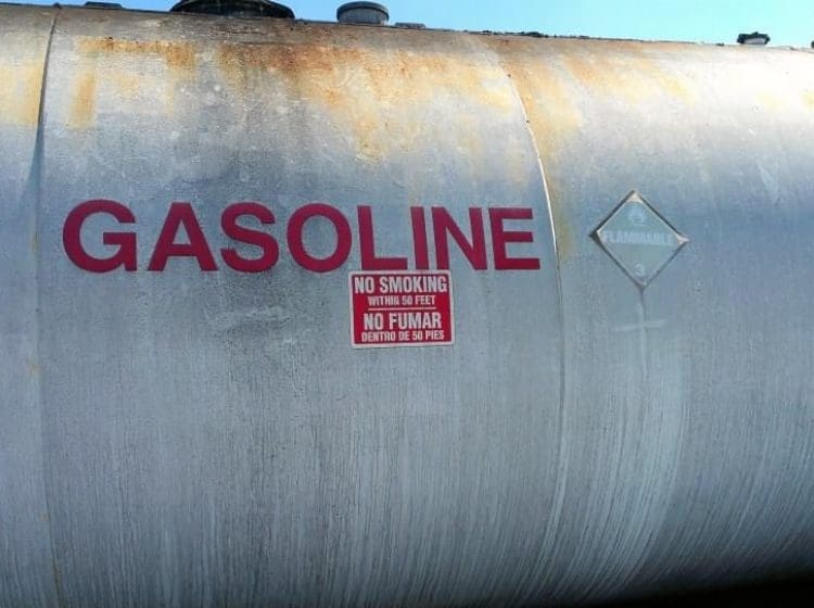 Weathered gasoline storage tank with visible rust and 