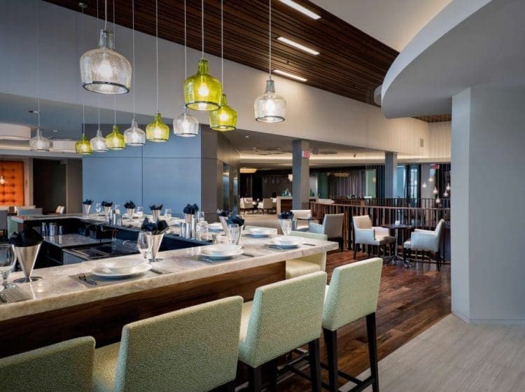 A stylish restaurant dining area with modern lighting, sleek countertops, and contemporary seating.
